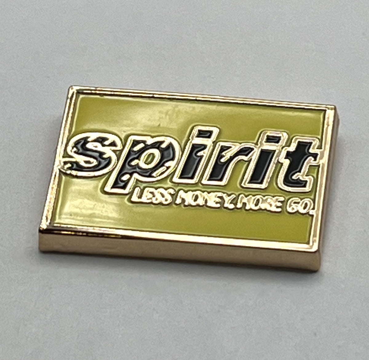 Spirit Airlines yellow wordmark lapel pin — modern cloisonné reproduction.
