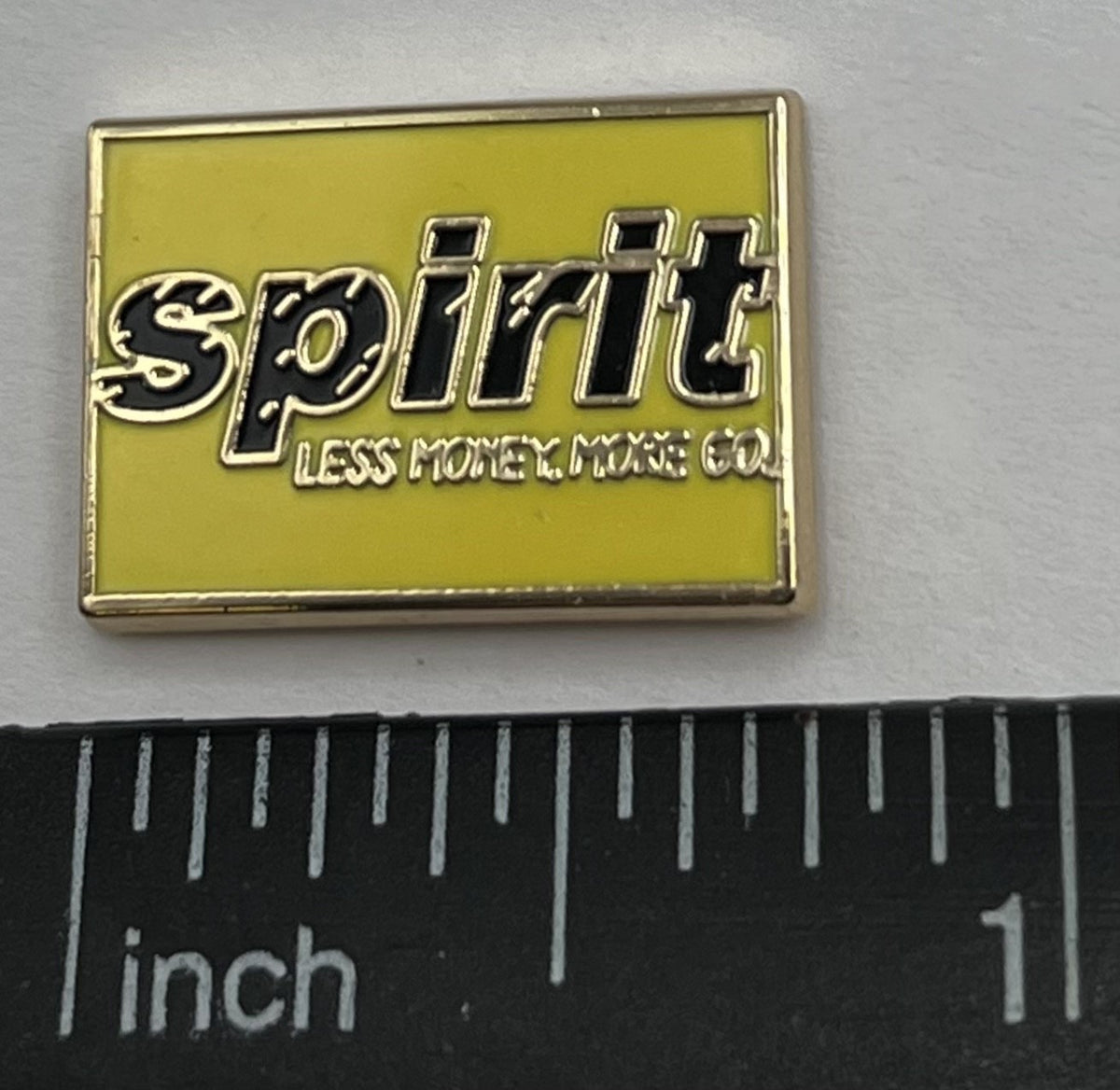 Spirit Airlines yellow wordmark lapel pin — modern cloisonné reproduction.