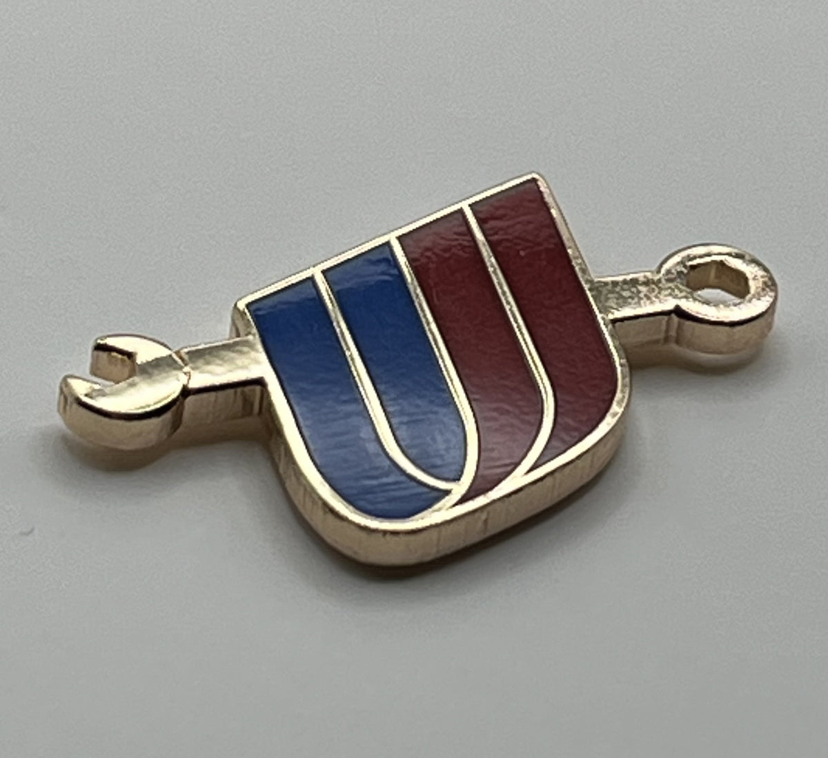 United Airlines tulip-and-wrench maintenance lapel pin — modern cloisonné reproduction