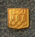 Hilton gold tone 1984 Los Angeles Olympic sponsor lapel pin